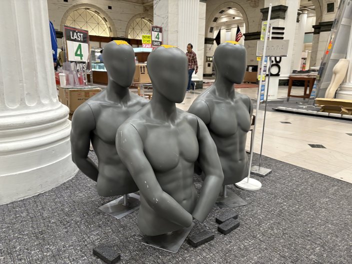 Three black mannequin heads and torsos