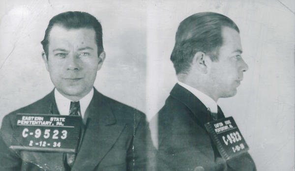 Black-and-white mugshots of a man in a suit