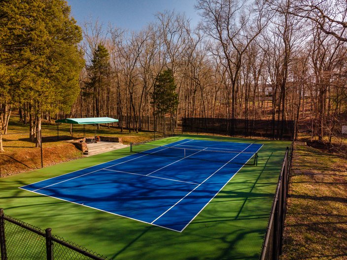 Blue tennis court in the woods of Newtown, Bucks County