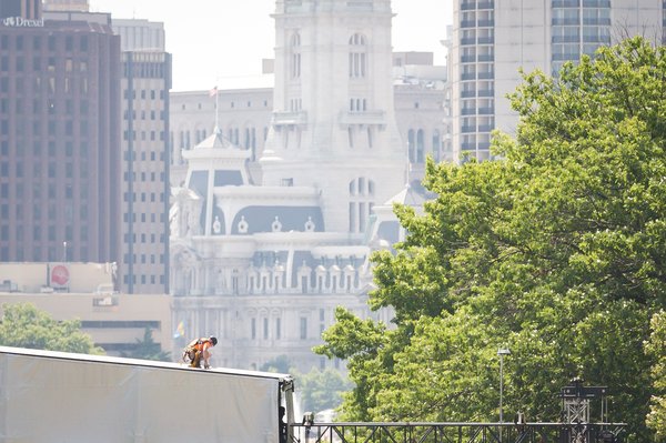 Carroll - A construction worker assembles a stage in hot weather for Wawa Welcome America