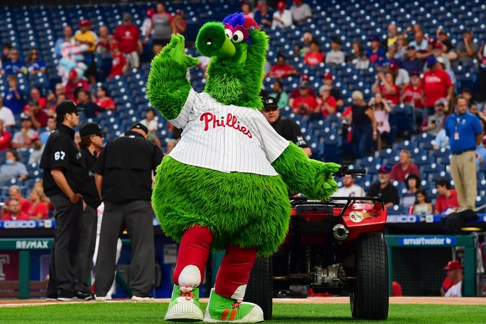 Phillie Phanatic mascot stands on a baseball field