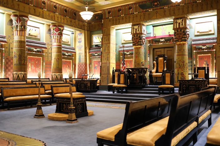 Painted columns, blue carpet and yellow benches make up the Egyptian Hall inside the Masonic Temple, Library & Museum in Philadelphia