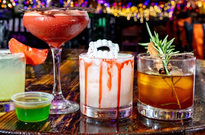 Halloween cocktails from Craftsman Row Saloon featuring fake vampire teeth, rosemary and other garnishes
