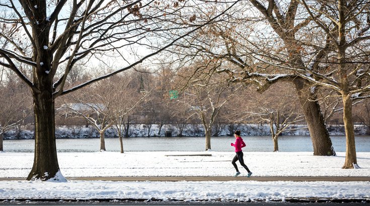 Woman running along river banks ibx rej