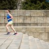 Woman running up steps in Philadelphia