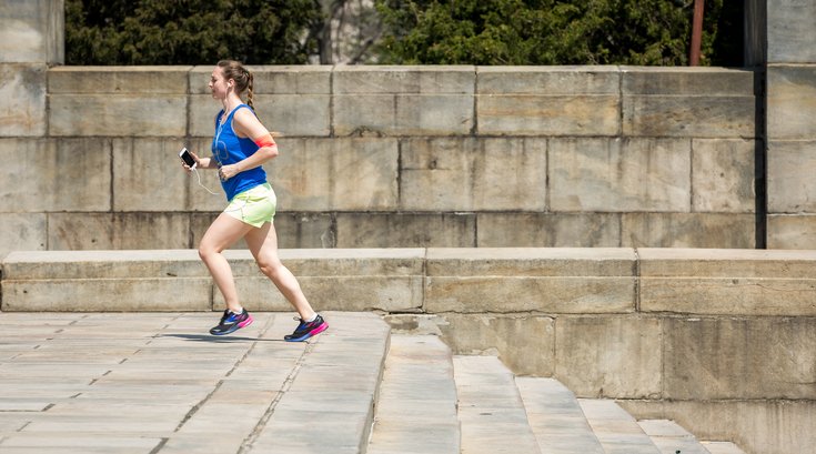Woman running up steps in Philadelphia