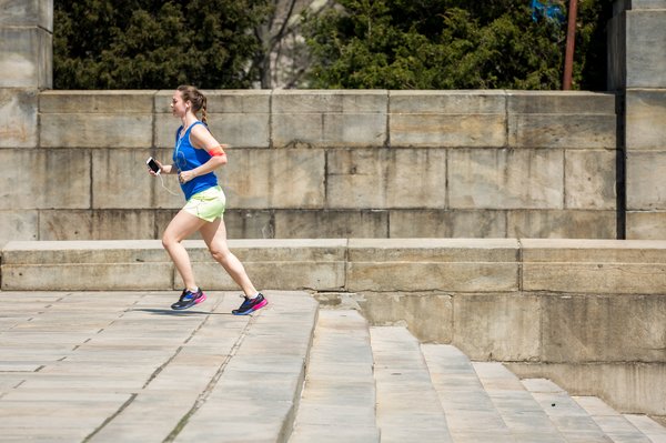 Woman running up steps in Philadelphia