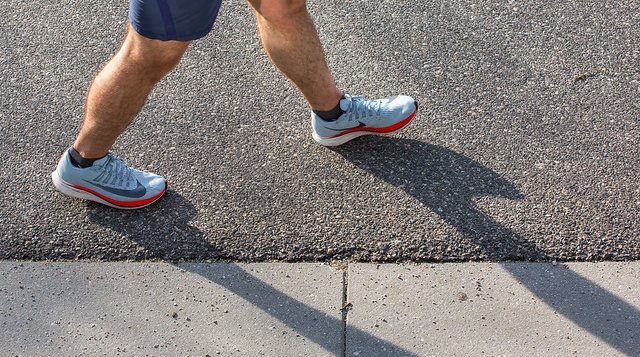 Person walking in street with sneakers