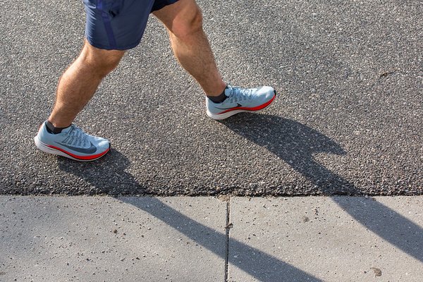 Person walking in street with sneakers
