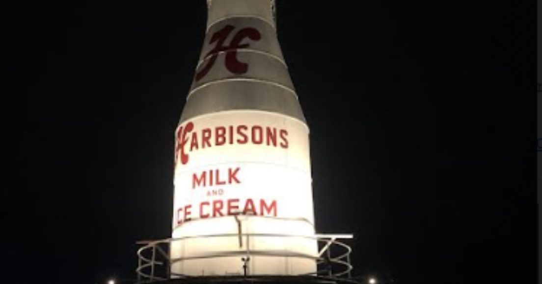 Historic Harbisons Dairy milk bottle illuminated atop Kensington apartment complex - Vimarsana News