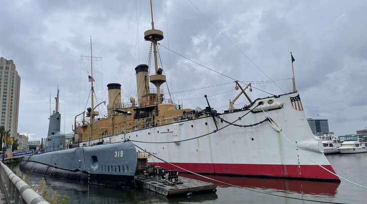 USS Olympia illuminated against the Delaware River