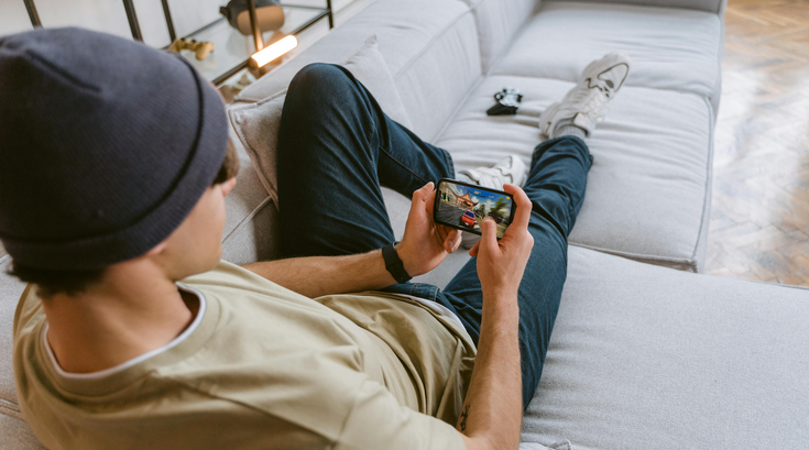 Young person playing a game on a couch