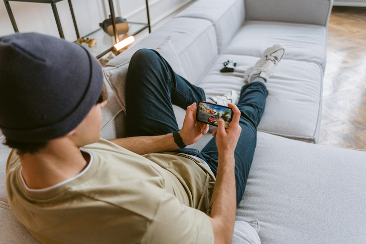 Young person playing a game on a couch