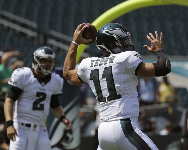 090315_Tebow-Barkley_AP