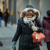 Woman in a coat outside in the winter during a cold day