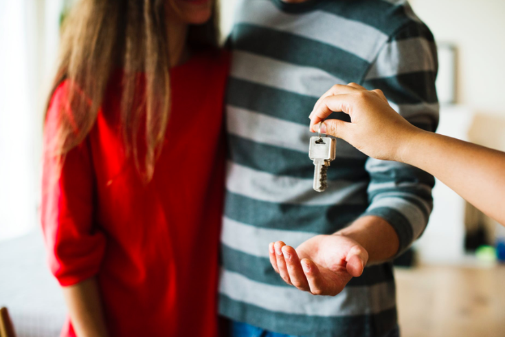 Couple receiving keys to home