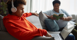 Purchased - Teen with laptop and mom in background