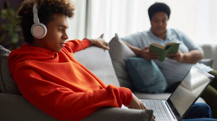 Purchased - Teen with laptop and mom in background