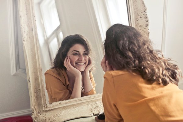 Woman looking into mirror