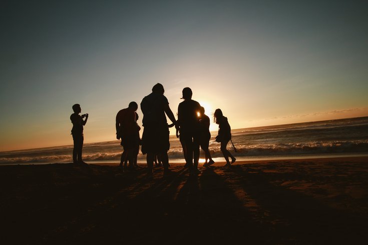 silhouette of friends on beach
