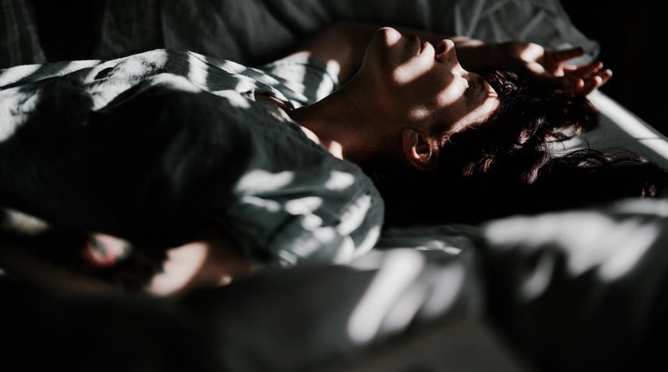 Person lying wide awake in bed