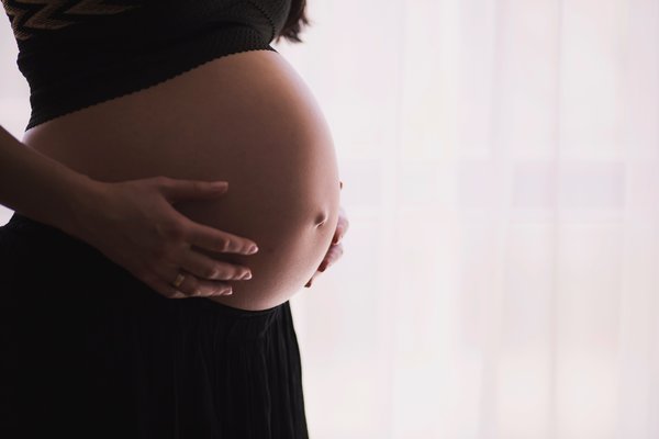 Pregnant woman holding stomach