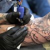 A person getting tattoo on their arm