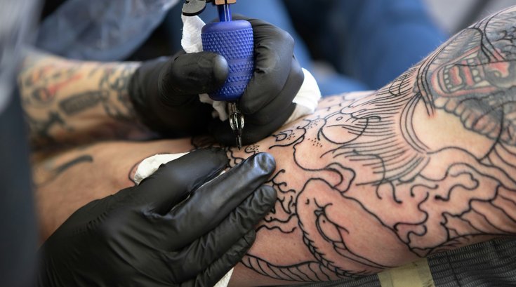 A person getting tattoo on their arm