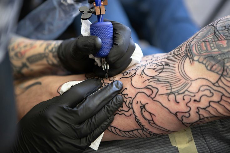 A person getting tattoo on their arm