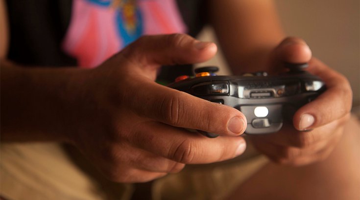 Person holding video game controller