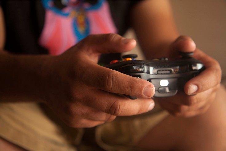 Person holding video game controller