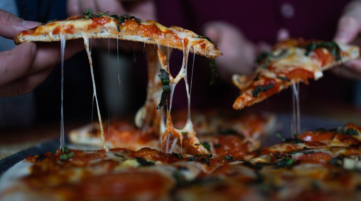 sharing pizza at restaurant
