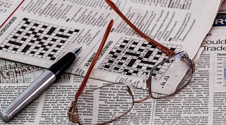 Glasses on newspaper crossword puzzle