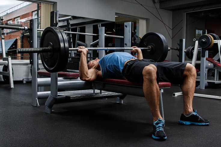 Man using a weight bench at gym