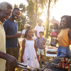 Purchased - a family barbecuing outside