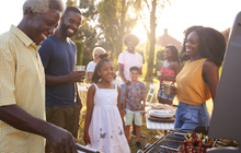Purchased - a family barbecuing outside