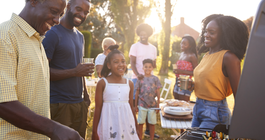 Purchased - a family barbecuing outside