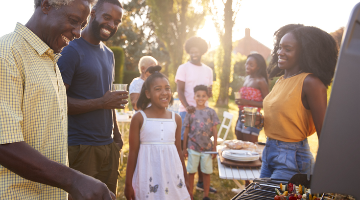 Purchased - a family barbecuing outside