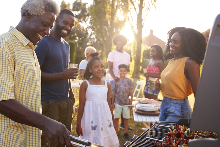 Purchased - a family barbecuing outside