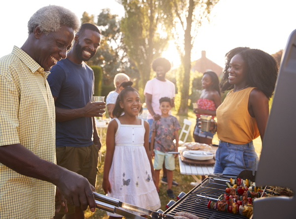 Purchased - a family barbecuing outside