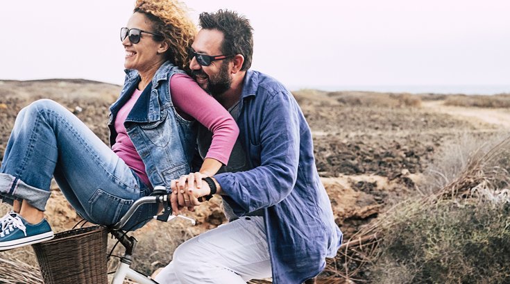 Middle ages couple riding a bike