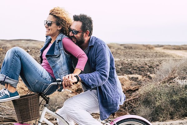 Middle ages couple riding a bike
