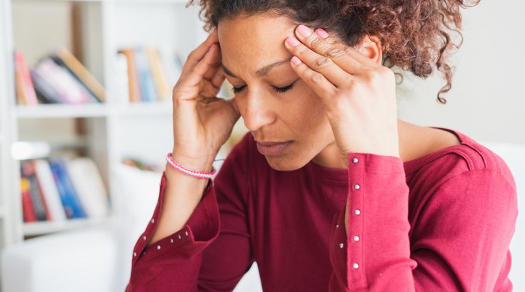 Purchased - Woman suffering from a migraine