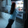 Purchase - Woman searching for a snack in the fridge