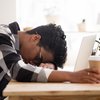 Person sleeping on their desk after no sleep