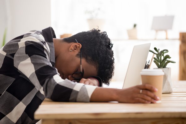 Person sleeping on their desk after no sleep