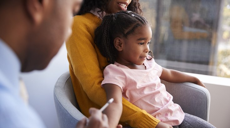 Mother Taking Young Daughter For Vaccination In Doctors Office