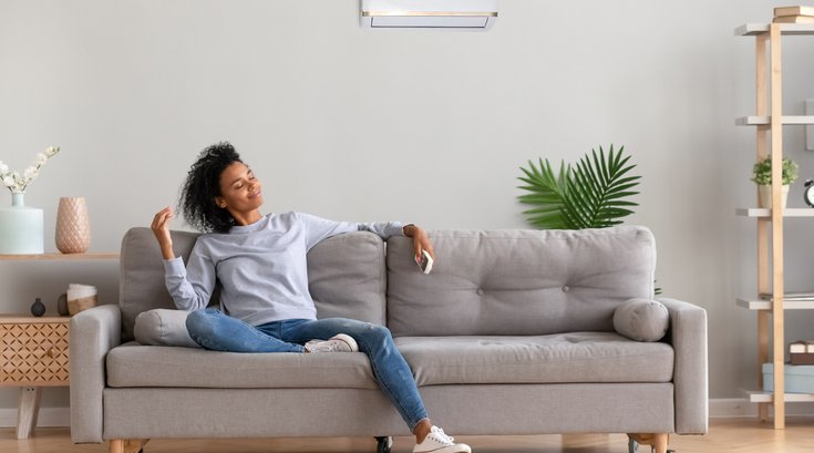 Purchased - relaxed woman sitting on couch breathing fresh air