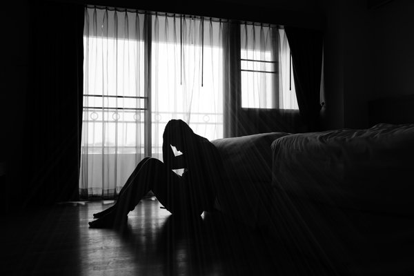 Purchased - A person sitting on the floor depressed