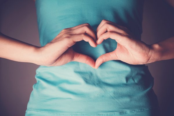 Purchased - Person making heart sign over their stomach
